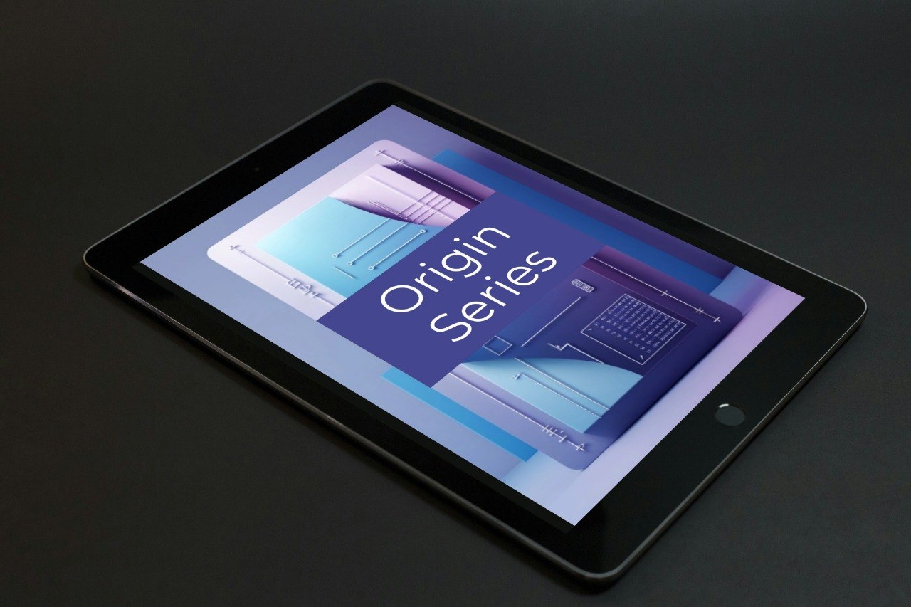 A black tablet device shown at an angle on a dark surface, with its screen on displaying a blue and purple graphic that reads 'Origin Series'.